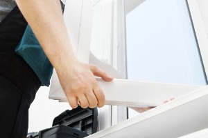 A technician readjusting a residential window in its frame during Window Repair in Bushnell IL