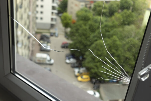 Replacement Windows Macomb IL, Crack, Broken Glass In A Double-glazed Window Due To Manufacturing Defect In Building, Home. Guarantee Manufacturer's Defective Products. Warranty. Horizontal Plane. Closeup. High quality photo